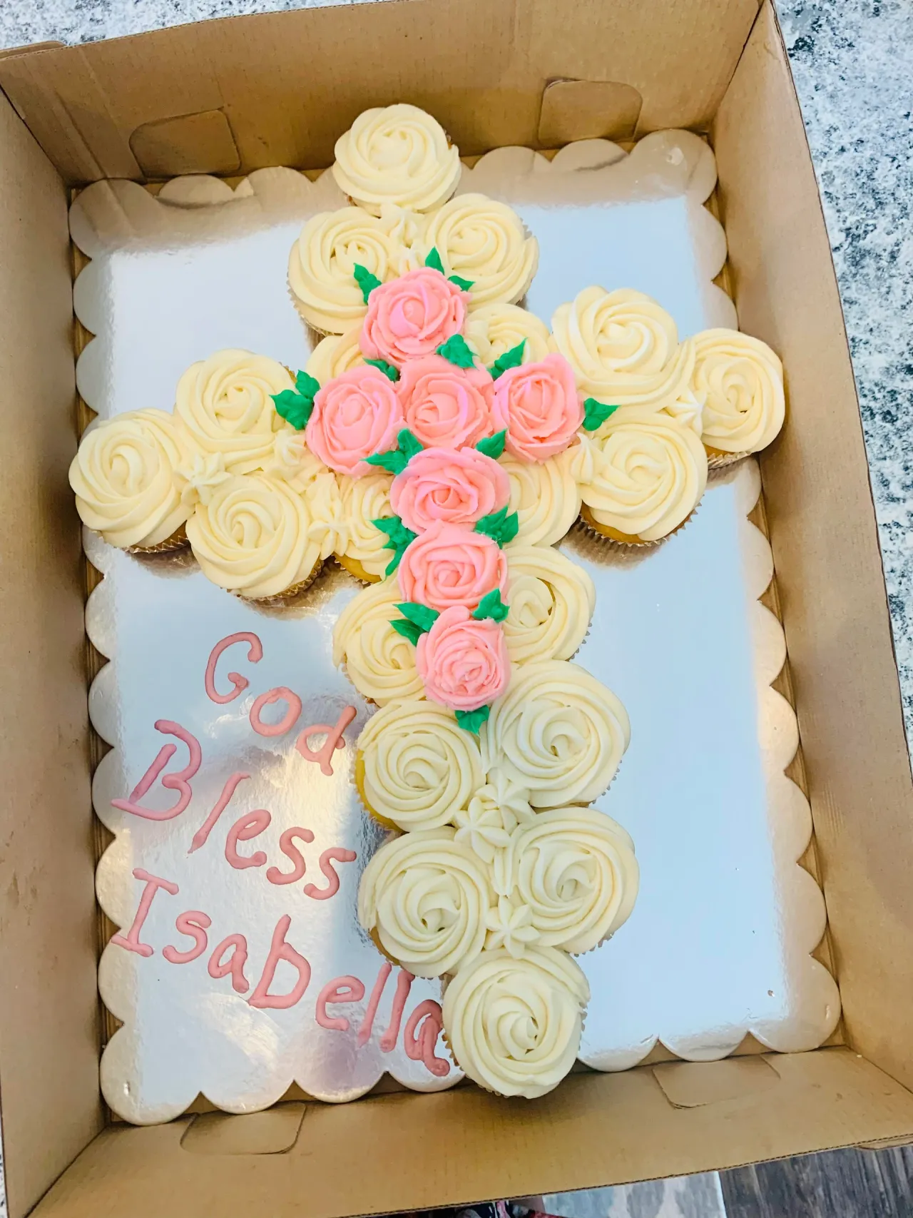 Cross-shaped cupcake cake with pink roses