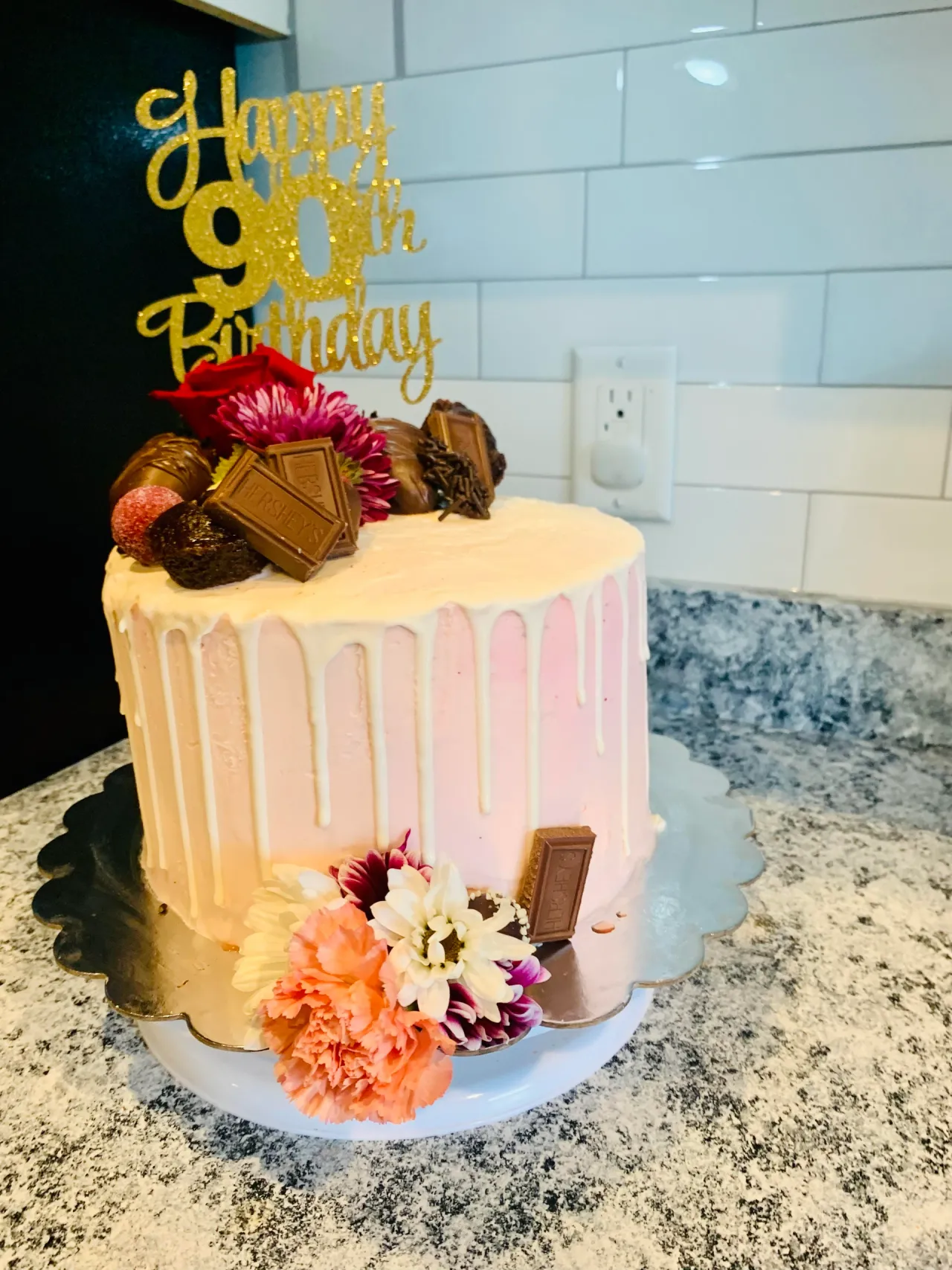 Elegant custom celebration cake with flowers and chocolate
