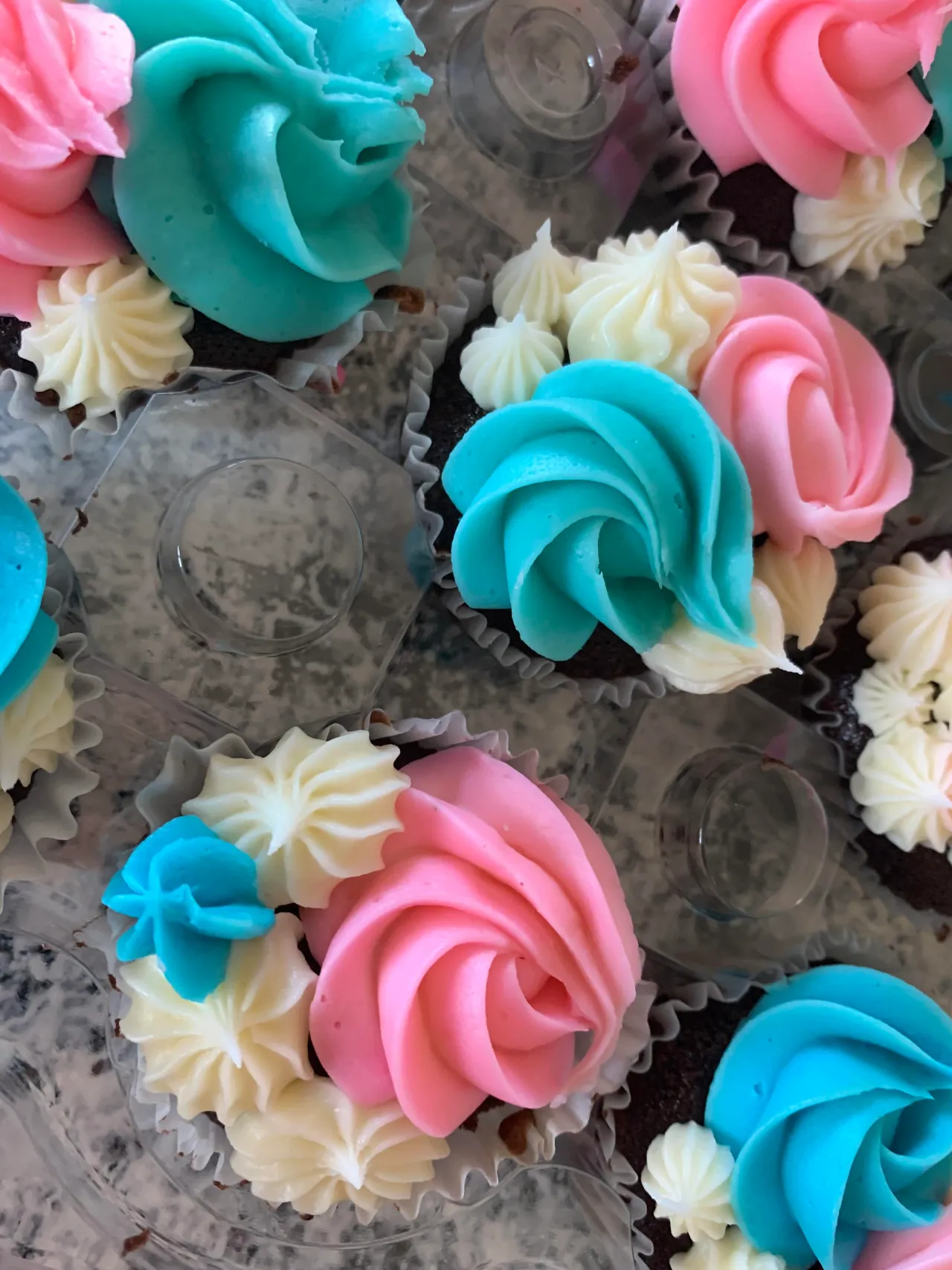 Pink and blue flower-piped cupcakes