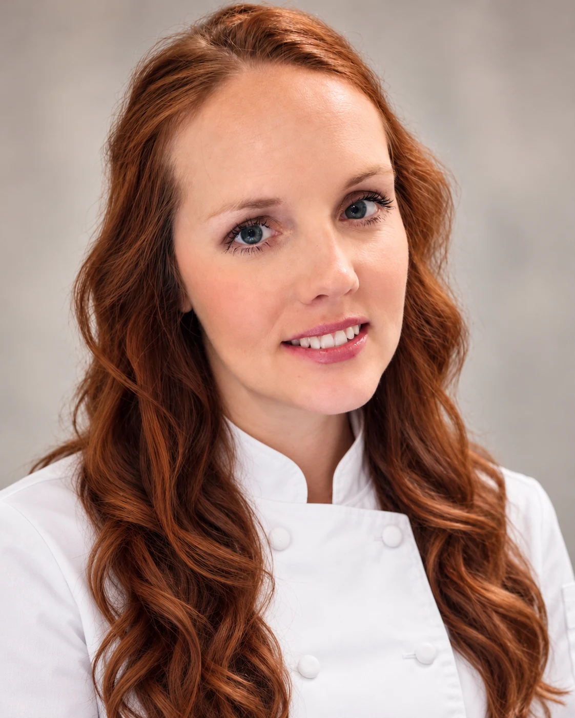 Rosie Shultz, owner of Texas Rose Cakeries, wearing a professional chef coat