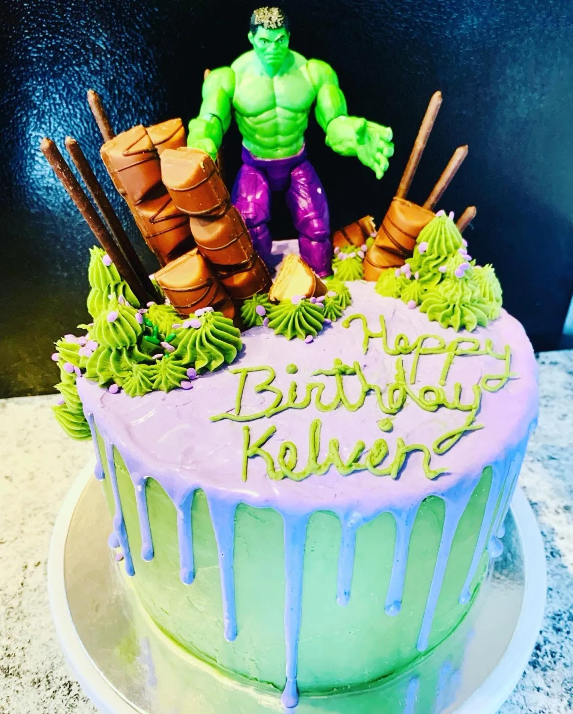 Green superhero themed birthday cake